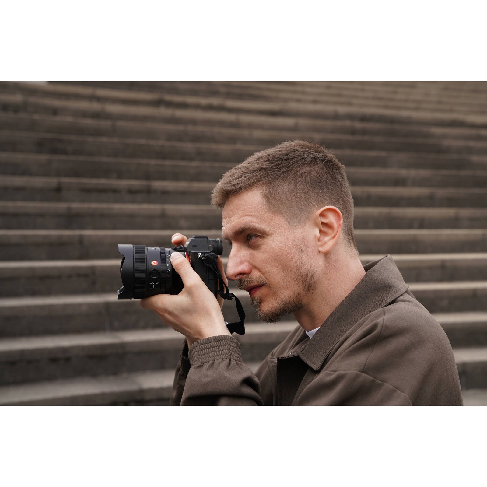 Sony FE 14mm f/1.8 GM held in hand to show its size