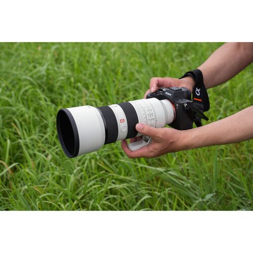 The Sony FE 70-200mm f/2.8 GM II held in hand to show its size